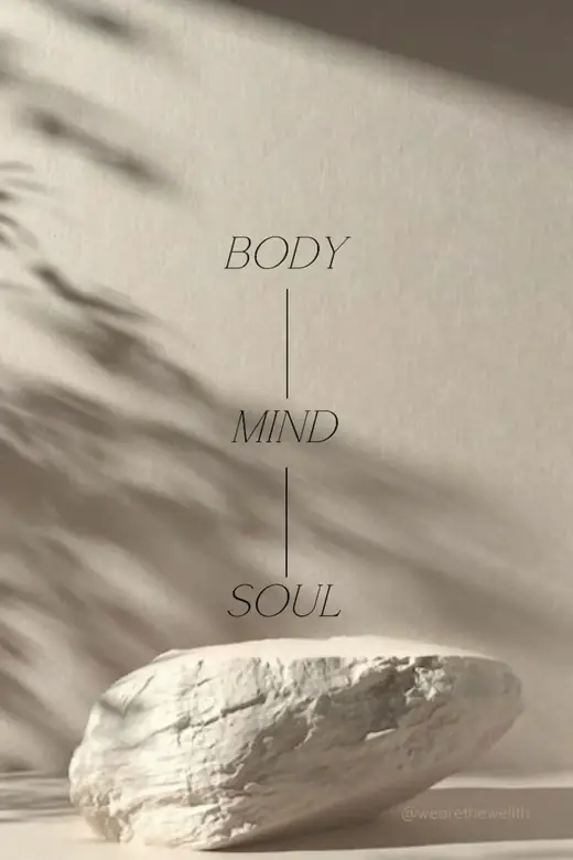 A pale stone in soft light beneath the words body, mind, soul