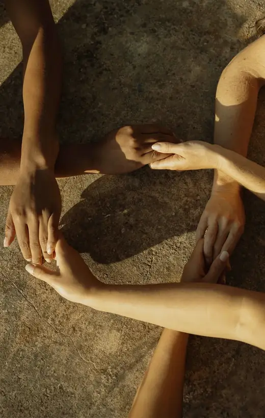 Hands resting together in warm daylight, a quiet moment of support